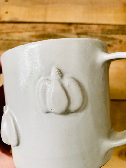 Mug with small white pumpkins