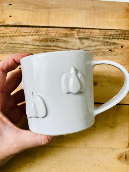 Mug with small white pumpkins